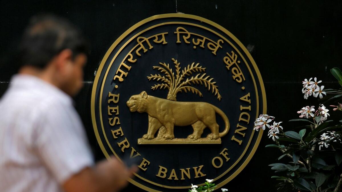 A man checks his phone outside the Reserve Bank of India (RBI) headquarters in Mumbai, India.- Reuters