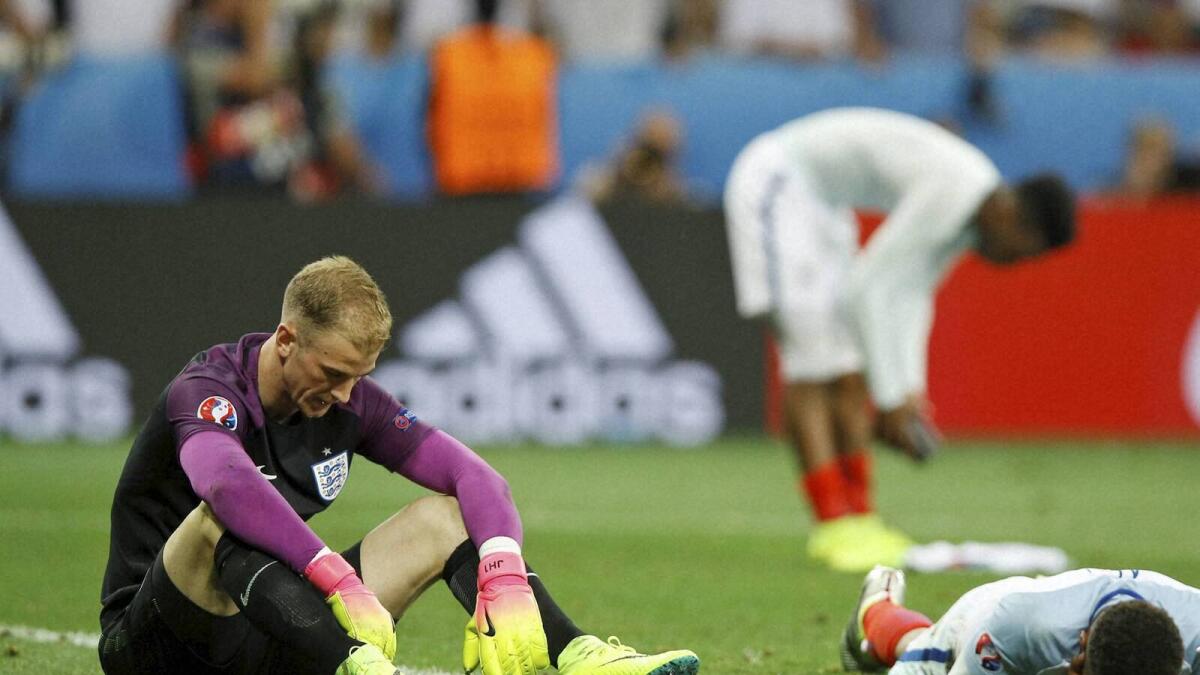 England goalkeeper Joe Hart (left) and his teammates react at the end of the Euro match against Iceland. — AP