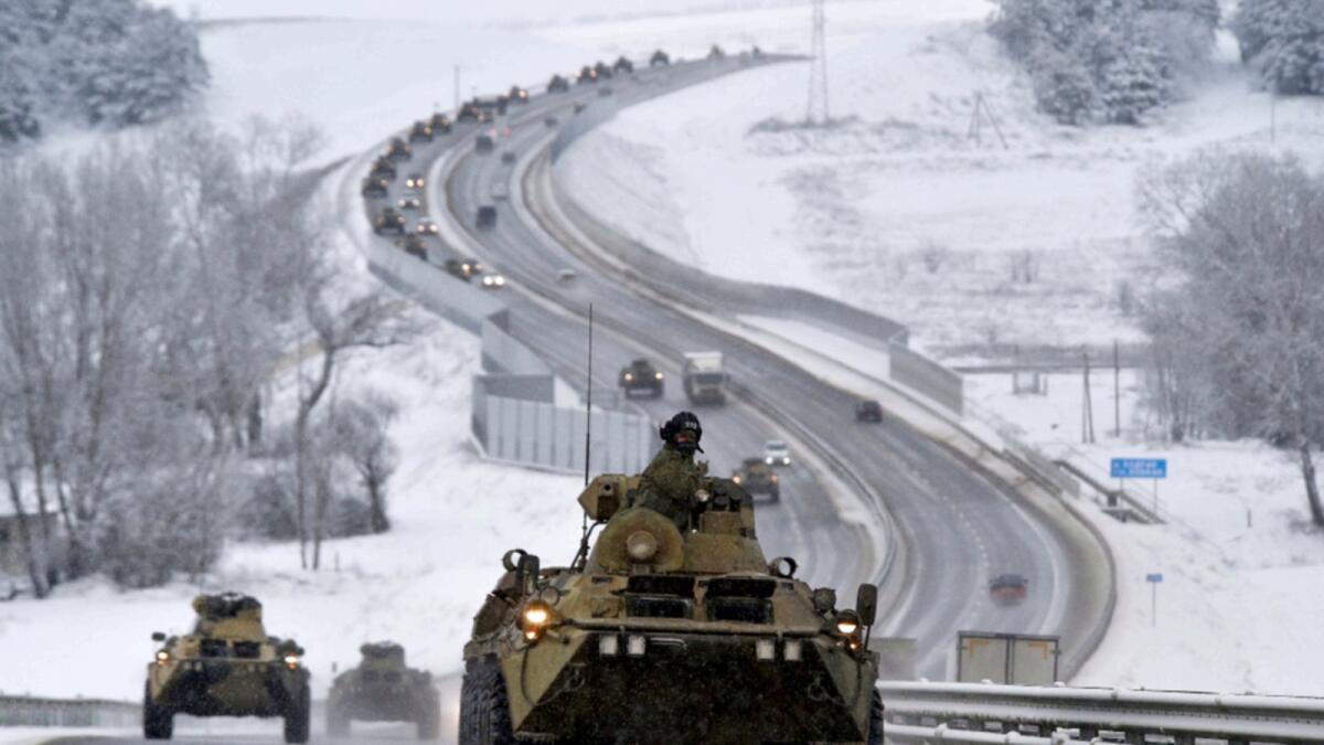 A convoy of Russian armored vehicles moves along a highway in Crimea. — AP