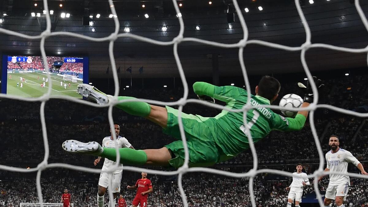 Real Madrid goalkeeper Thibaut Courtois (centre) saves a shot from Liverpool's Mohamed Salah. (AFP)