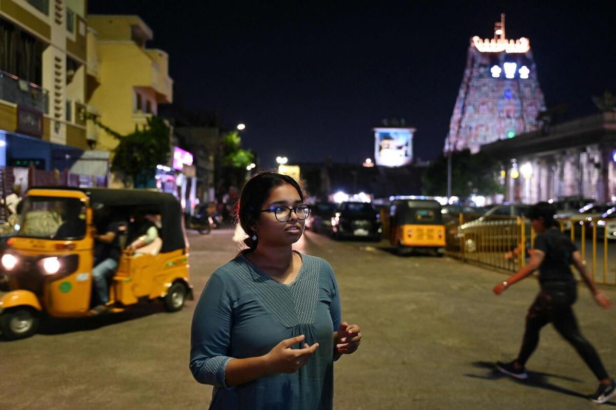 Thrishalini Dwaraknath, a computer science student who will be voting for the first time in India's upcoming general election, poses along a street in Chennai.  — AFP