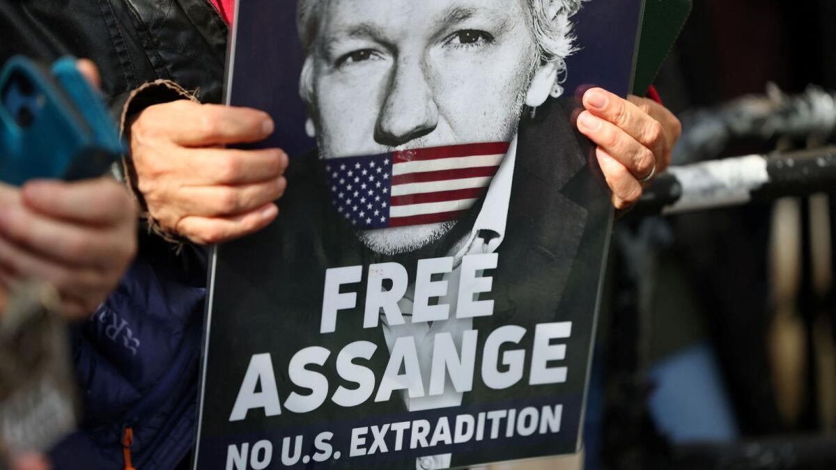 A supporter of WikiLeaks founder Julian Assange holds a sign, on the day the High Court is set to rule on whether Julian Assange can appeal against extradition from Britain to the United States in London on Tuesday. — Reuters