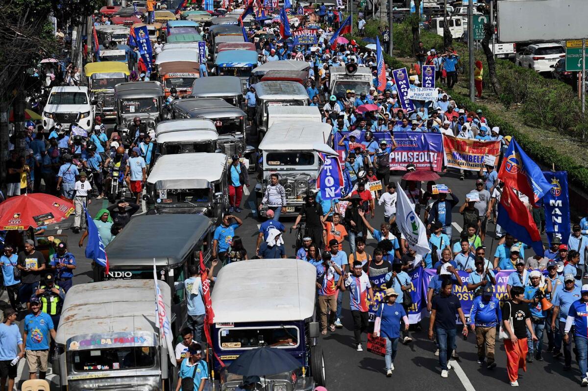 Jeepney drivers and operators march during a protest against the jeepney modernisation program in Manila on Tuesday.  — AFP
