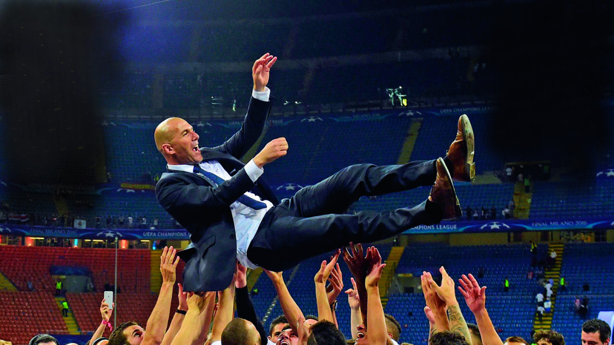 Real Madrid’s coach Zinedine Zidane is lifted by his players after Real Madrid won the Champions League final. — AFP