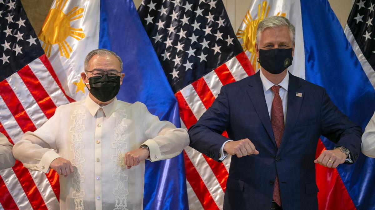 US National Security Advisor Robert O'brien, right, and Philippine Secretary of Foreign Affairs Teodoro Locsin Jr. elbow bump after the turnover ceremony of defence articles at the Department of Foreign Affairs in Pasay City,  Manila.