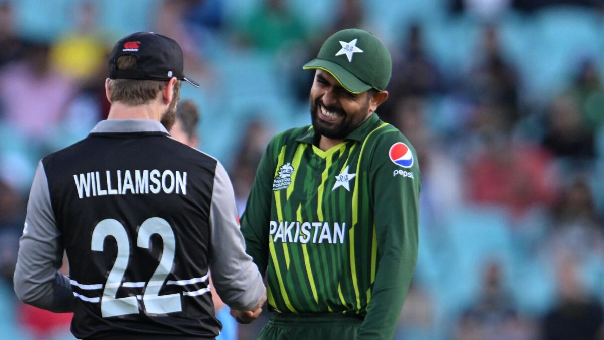 New Zealand's captain Kane Williamson and Pakistan's captain Babar Azam share a light moment as they shake hands ahead of the T20 World Cup semi-final match. Photo: AFP