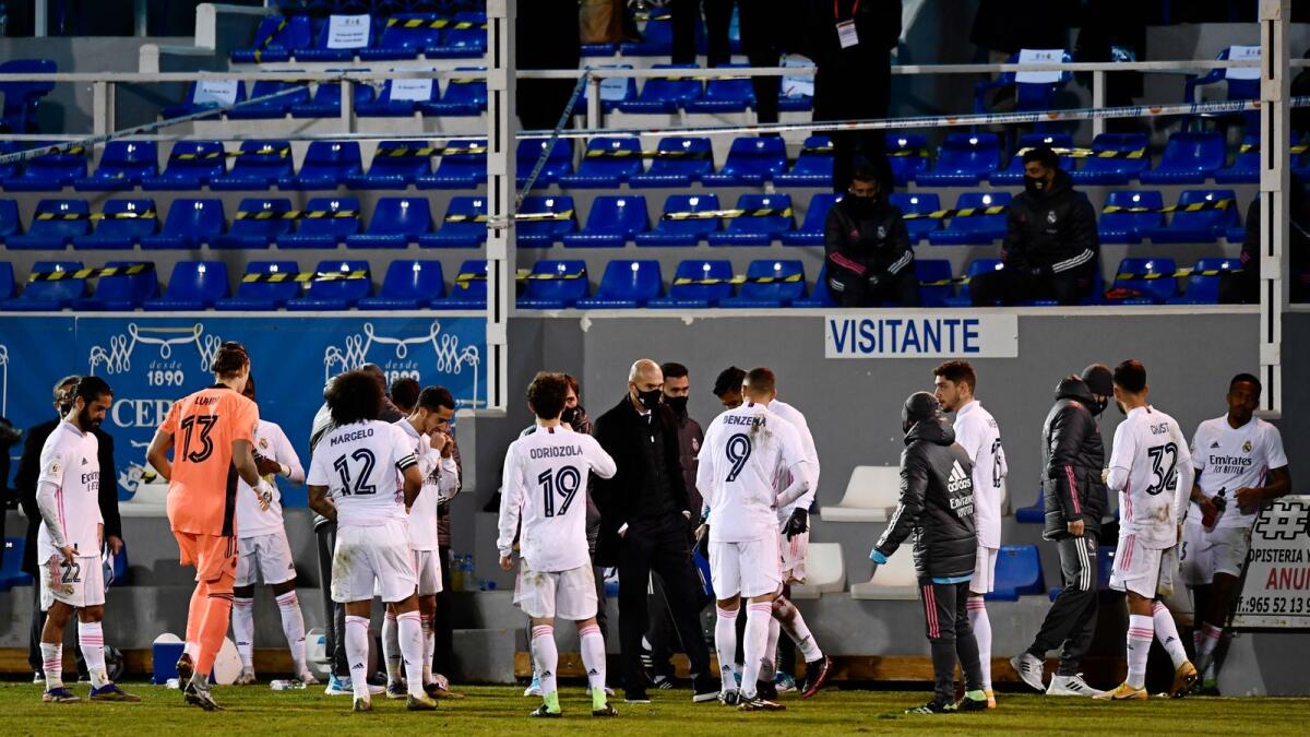 Real Madrid's head coach Zinedine Zidane (centre) speaks with his players. — AP