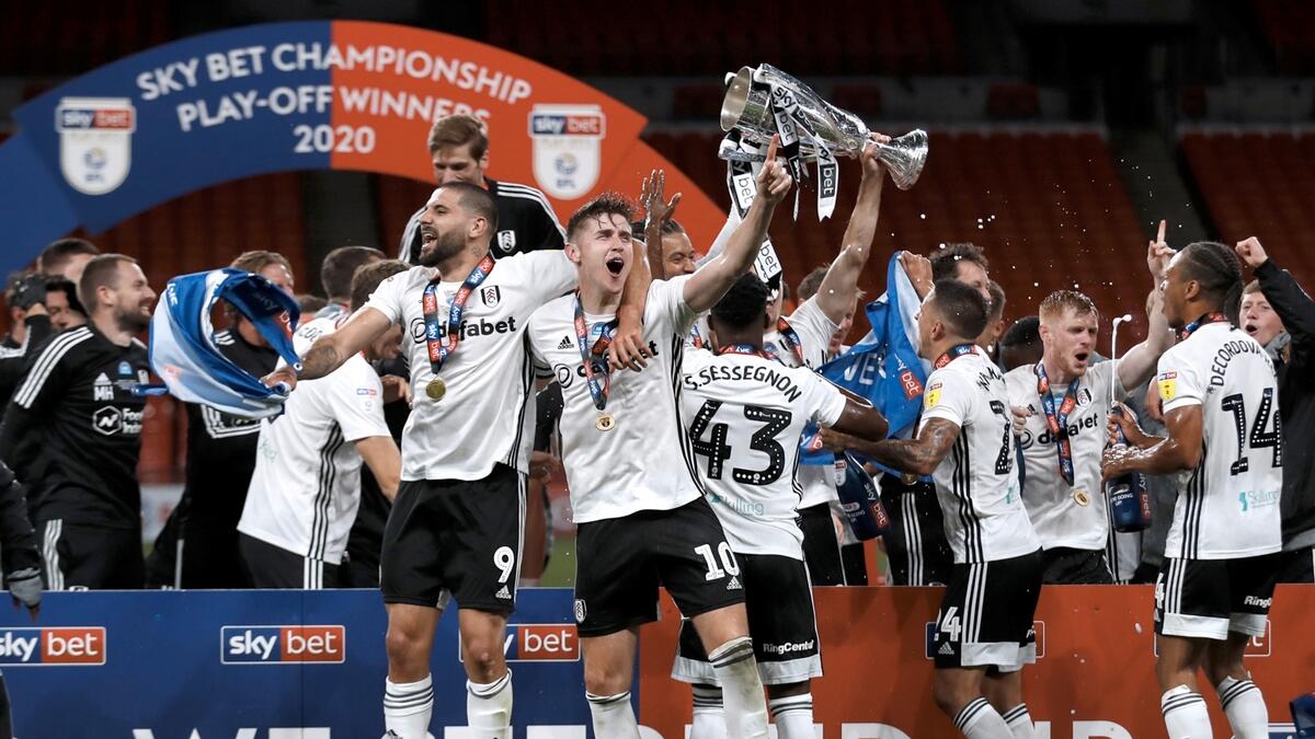 Fulham's Tom Cairney and Fulham's Aleksandar Mitrovic as they celebrate promotion to the premier league with teammates after winning the match, as play resumes behind closed doors following the outbreak of the coronavirus disease (Covid-19). Photo: Reuters