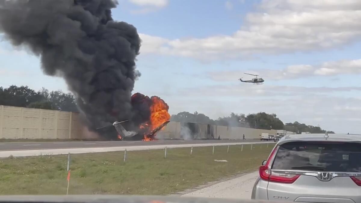 Smoke and fire fills the air after an airplane crashed on Interstate 75 near Naples, Florida. — AP