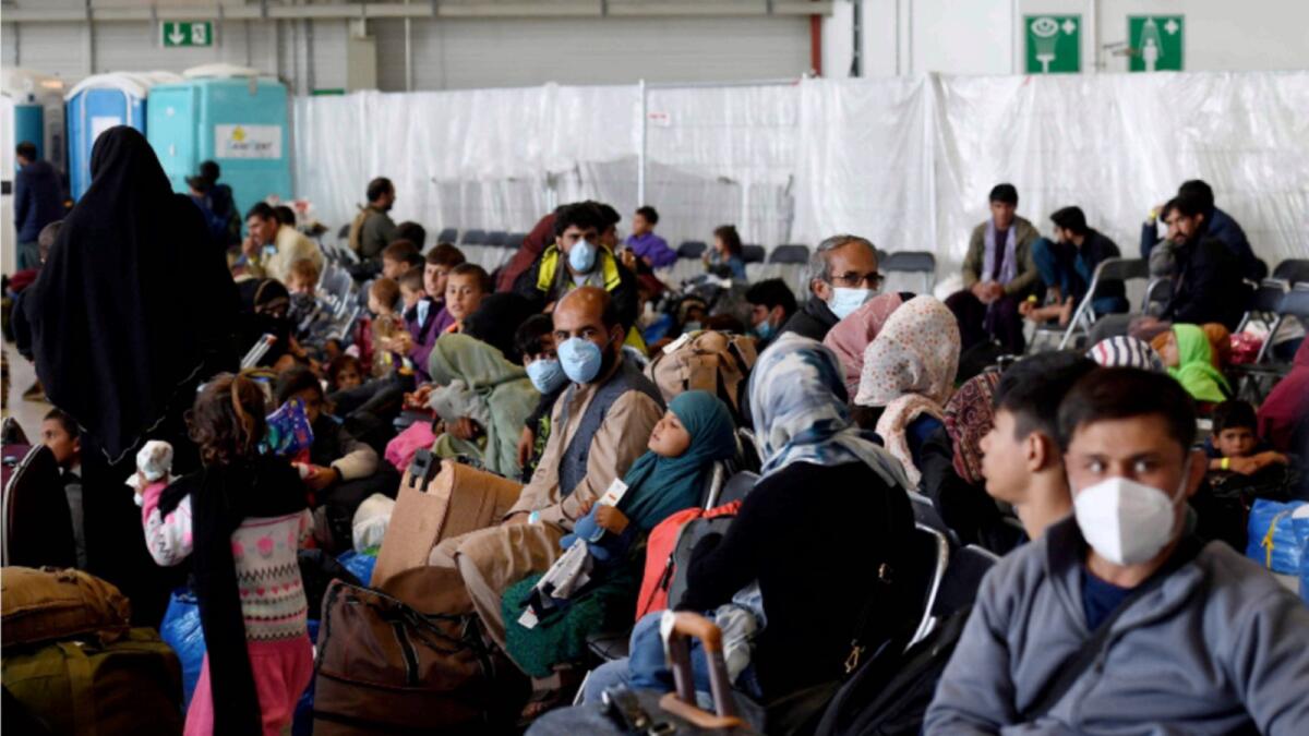 Afghan refugees are processed inside Hangar 5 at Ramstein Air Base in Germany. — Reuters