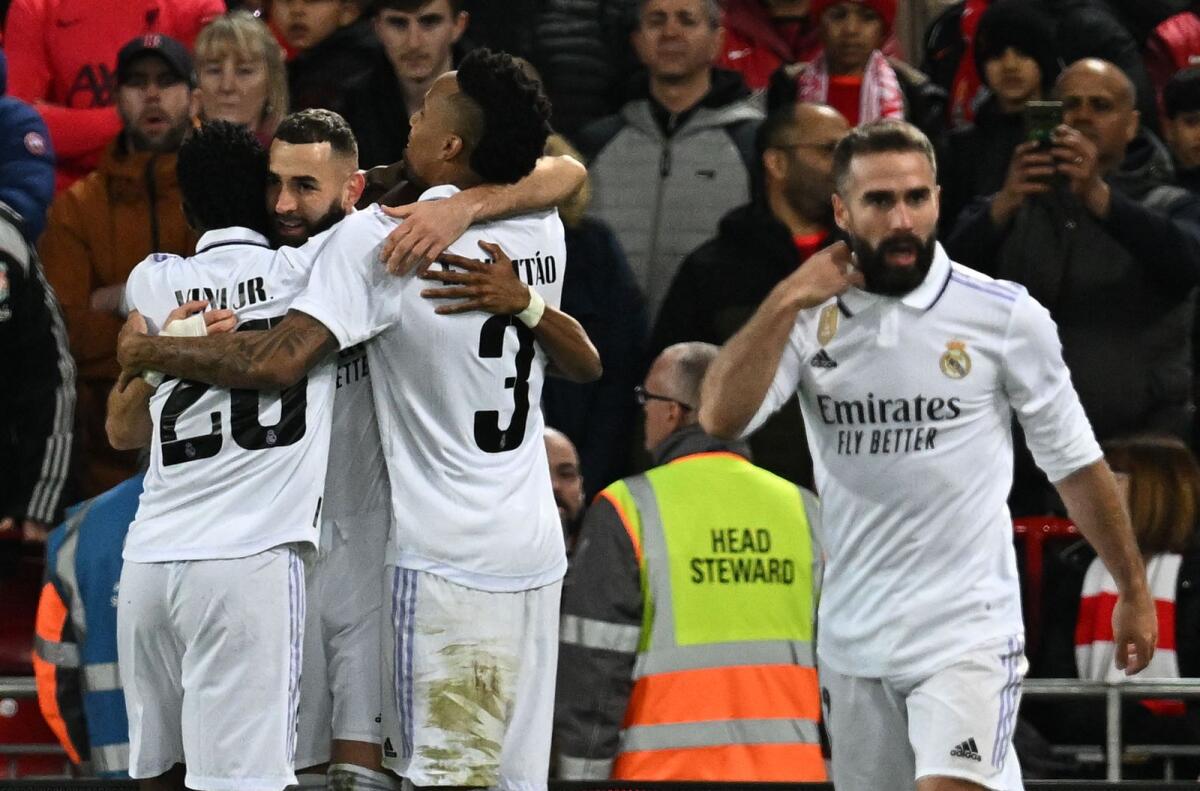 Real Madrid's Karim Benzema (second left) celebrates scoring the team's fourth goal against Liverpool. — AFP