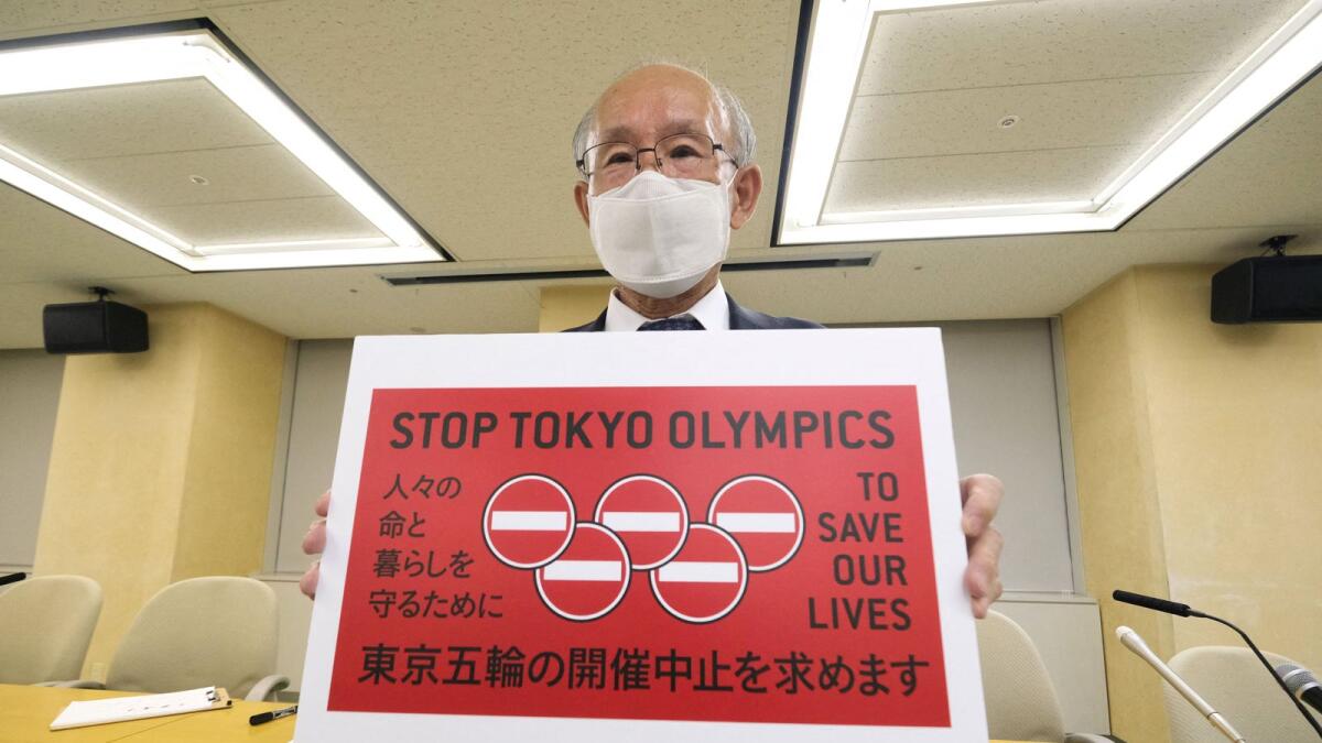 Kenji Utsunomiya, a Japanese lawyer, poses with a campaign slogan, Stop Tokyo Olympics, after handing the petition to the Tokyo Metropolitan Government on Friday. (AFP)
