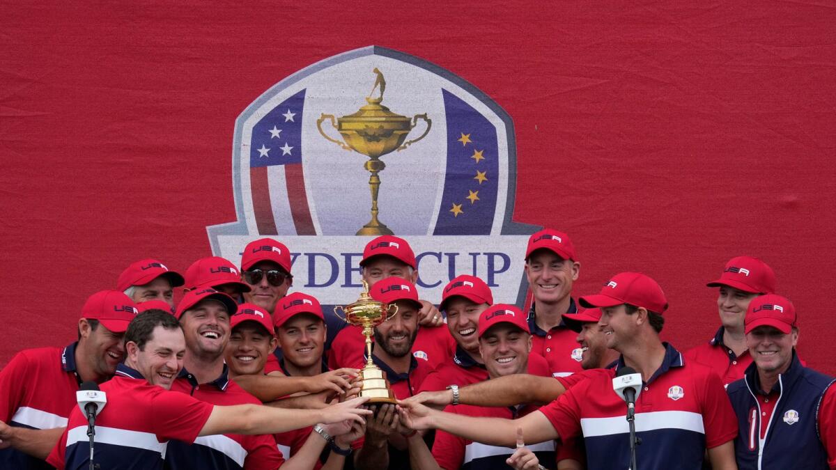 Team USA players pose with the trophy after their Ryder Cup win. (AP)