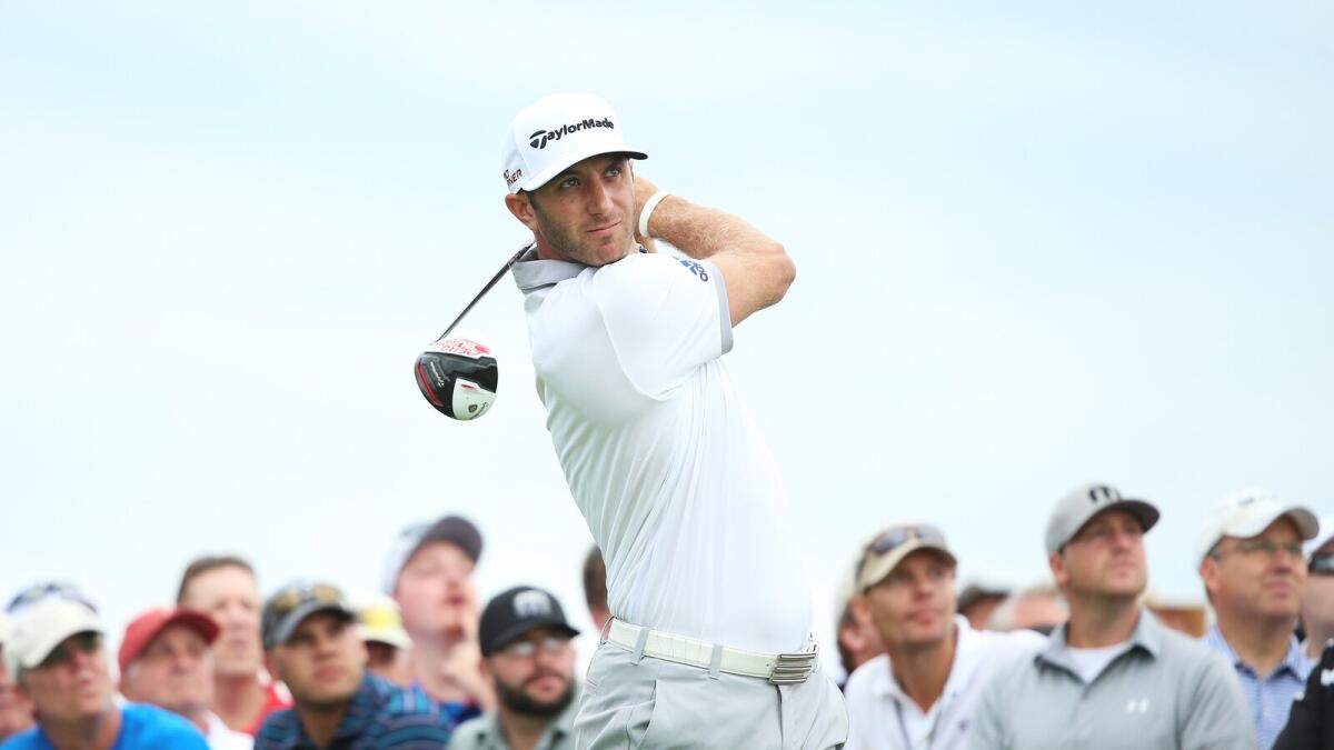 Dustin Johnson of the United States watches his tee shot on the 11th hole during the first round of the PGA Championship. 