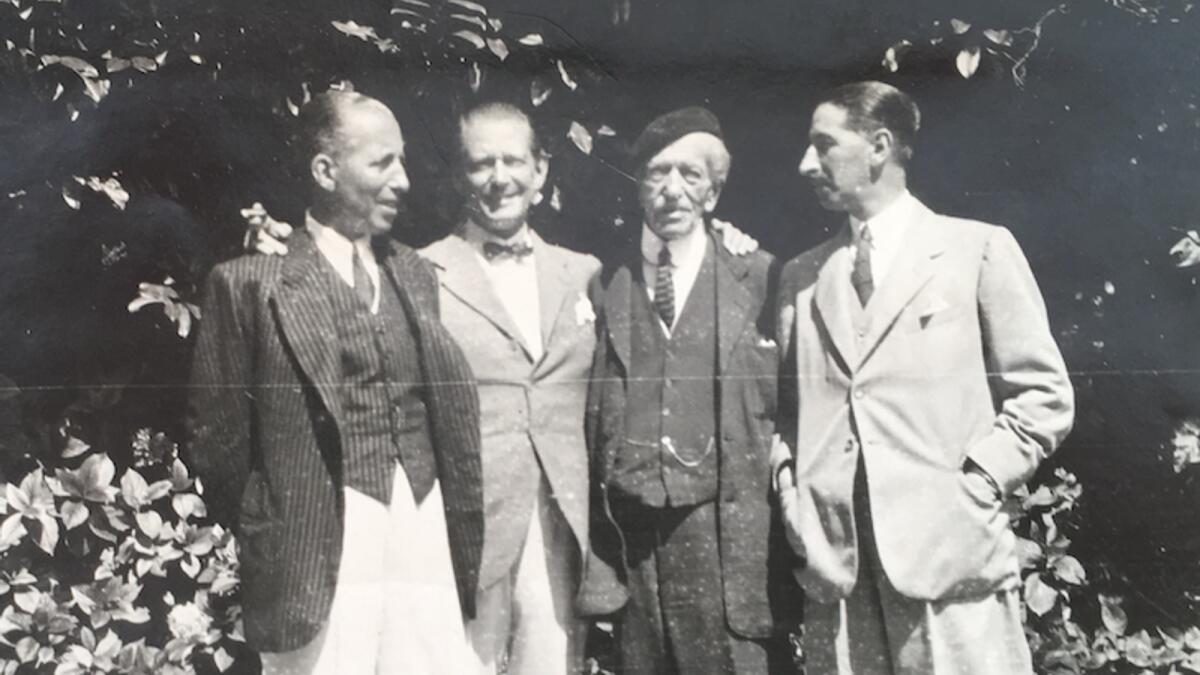 The three Cartier brothers with their father