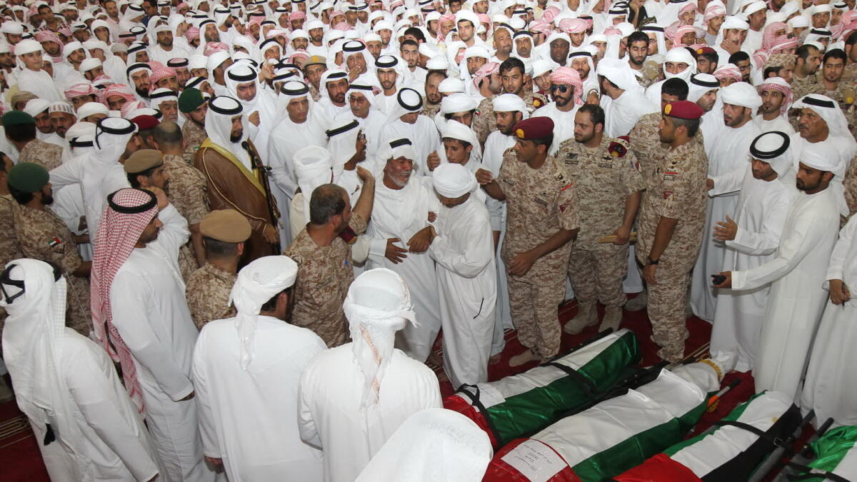 An elderly Emirati man being comforted after the death of UAE soldiers.