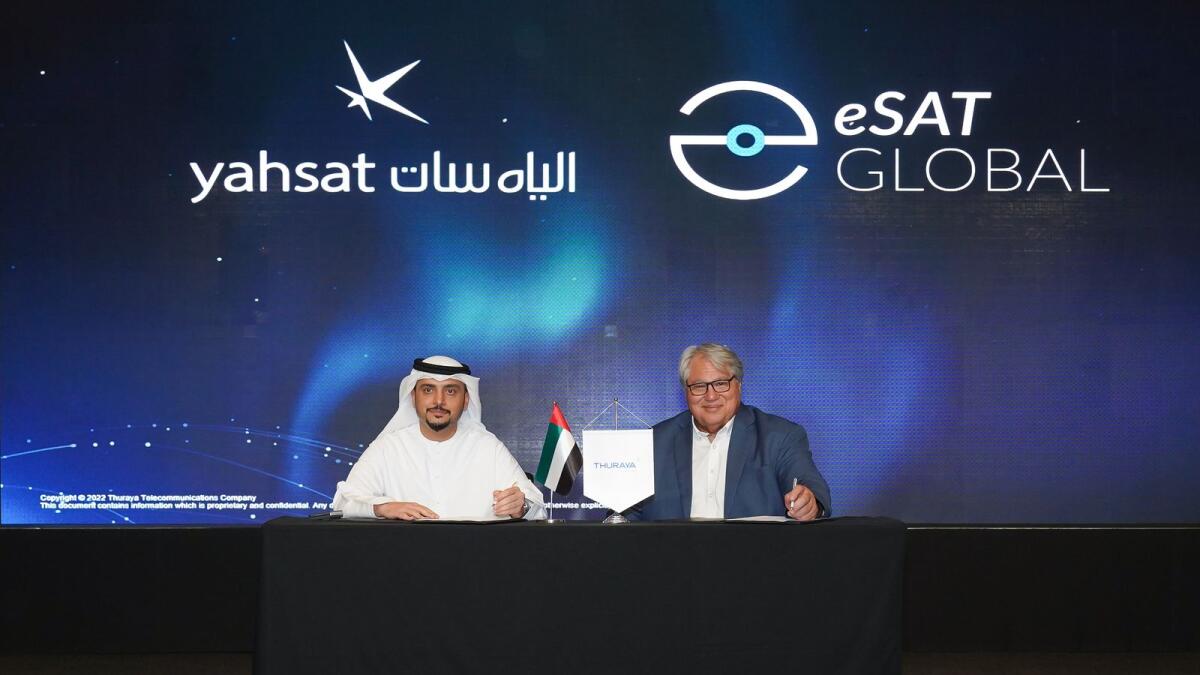 Ali Al Hashemi, chief executive officer at Yahsat Group, and Rick Somerton, CEO and president of eSat Global, signing the deal. — Supplied photo