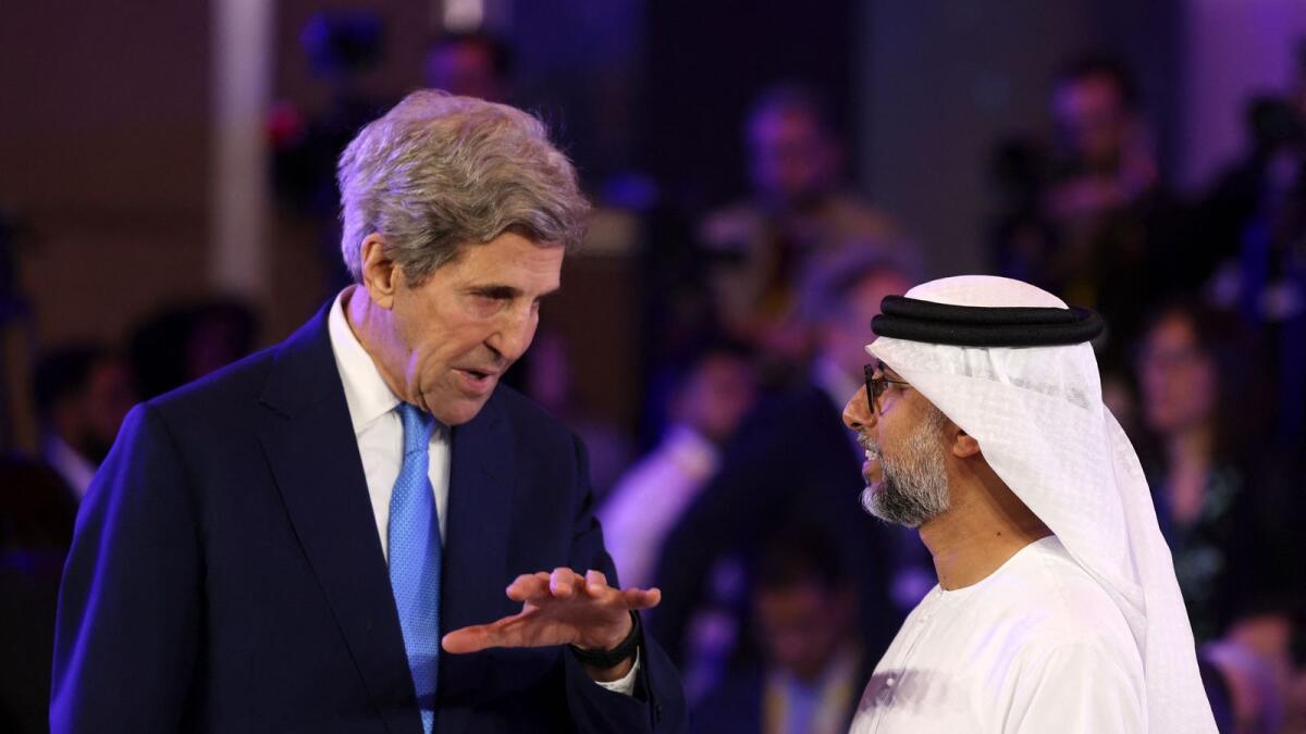 US Presidential Envoy for Climate John Kerry (L) speaks to UAE's Minister of Energy and Industry Suhail al-Mazrouei, at the opening session of the Atlantic Council Global Energy Forum, in the capital Abu Dhabi on Saturday. - AFP