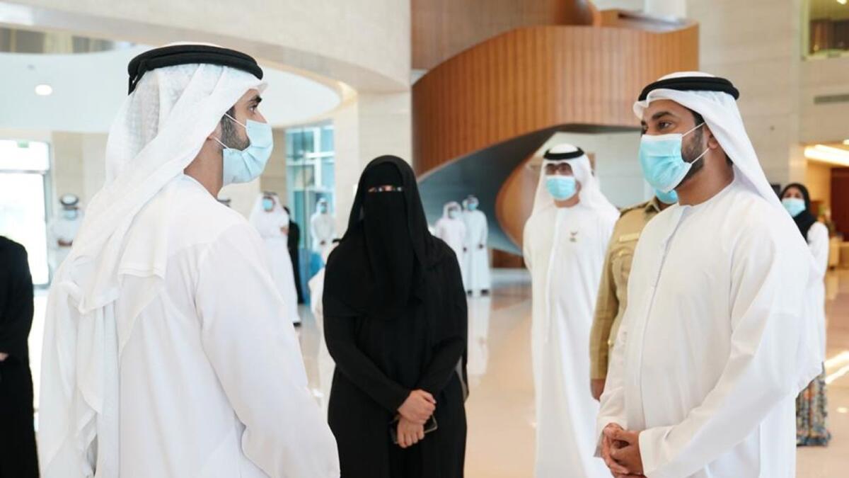 File photo features Sheikh Hamdan bin Mohammed bin Rashid Al Maktoum, Crown Prince of Dubai, being briefed by Ahmed Huraimel, Iman Bin Touq and other members of the government volunteer team.
