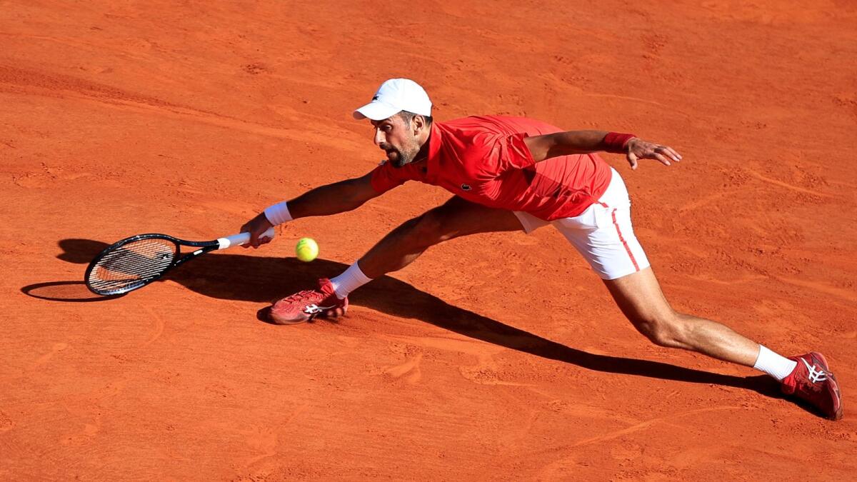 Serbia's Novak Djokovic hits a return to Australia's Alex De Minaur during their Monte Carlo ATP Masters Series Tournament. - AFP