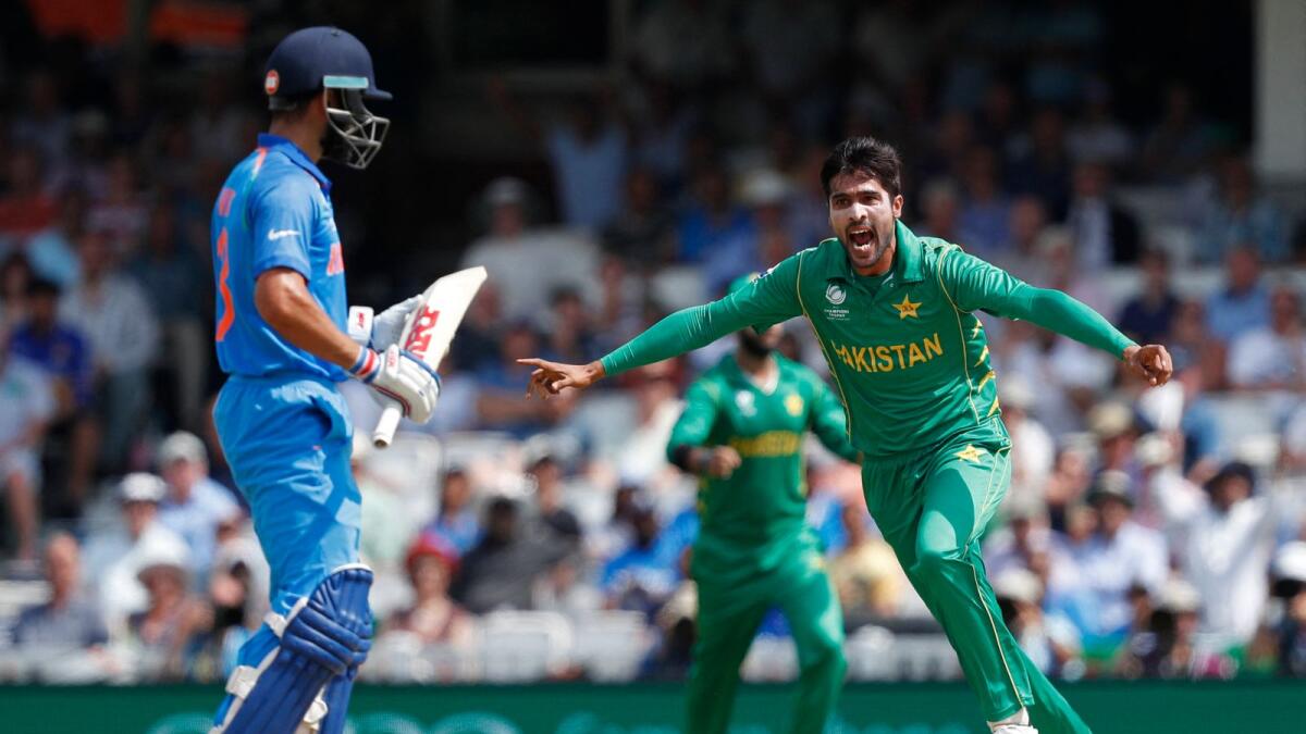 Pakistan's Mohammad Amir celebrates after taking the wicket of Indian captain Virat Kohli (left) during the ICC Champions Trophy final in London on June 18, 2017. (AFP)