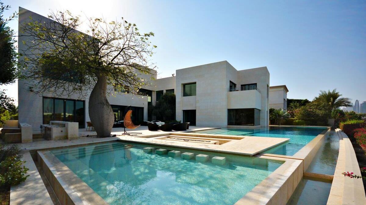 This Emirates Hills villa has six bedroom suites, an elevator, staff accommodation for eight maids or drivers and an infinity pool.