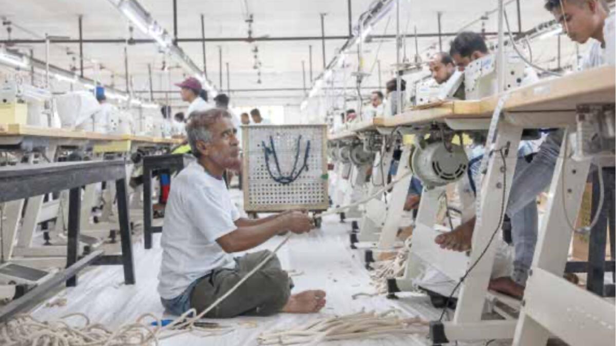 A worker pulling handles for reusable bags at the Ballyfabs International factory in Begumpur, India.
