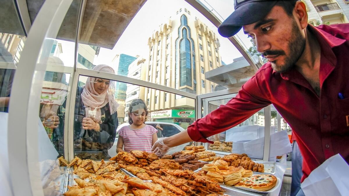 Which one is your favorite Iftar snack? A family buys iftar snacks from a Pakistani snack shop during the Holy month of Ramadan in Sharjah. Photo by M. Sajjad/Khaleej Times