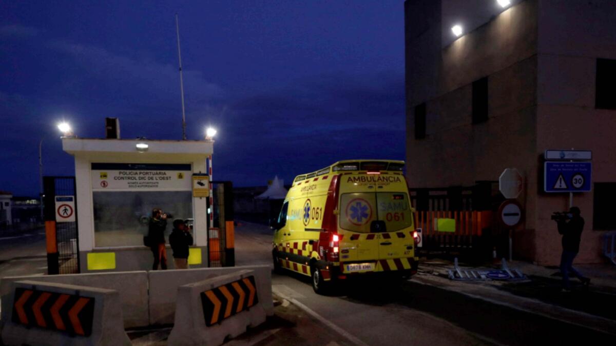 An ambulance enters the port of Palma de Mallorca as Spanish rescuers pulled 14 people to safety, in the sea off the Island of Cabrera, on Mallorca Island. — AFP