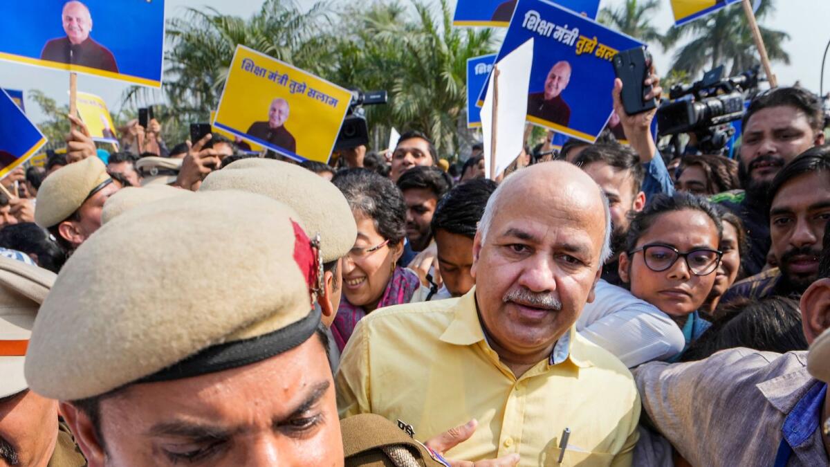 Delhi Police personnel escort Delhi Deputy Chief Minister Manish Sisodia form Rajghat ahead of his questioning by CBI in the liquor policy case in New Delhi on Sunday. — PTI