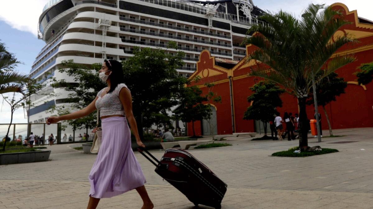 A passenger arrives to board at the cruise ship 'MSC Preziosa'', in the Port Area of Rio de Janeiro, Brazil, after Brazil's Sanitary Agency has confirmed more cases of COVID-19 on board. — AP