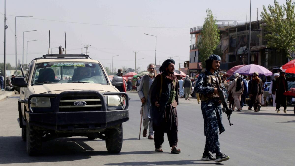Taliban fighters walk in the city of Kabul. — AP