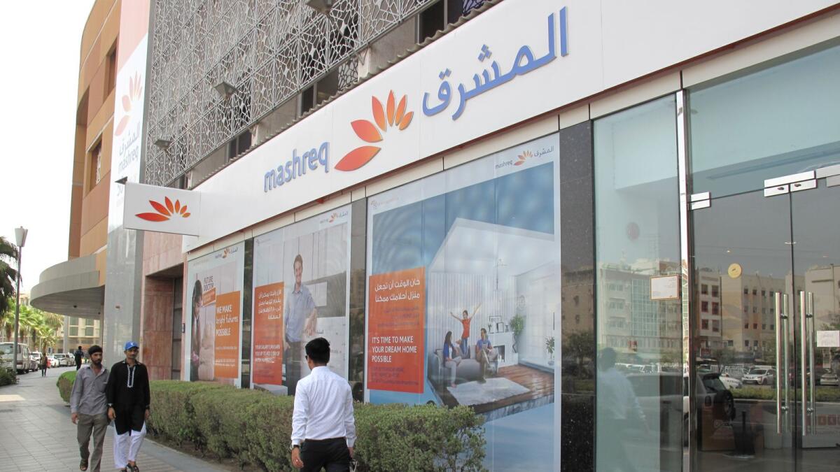 People walk past Mashreq bank in Dubai. Mashreq’s capital adequacy ratio stood at 16 per cent (post-recommended dividend) and Tier 1 Capital ratio at 13.7 per cent as of December 2022. — Reuters