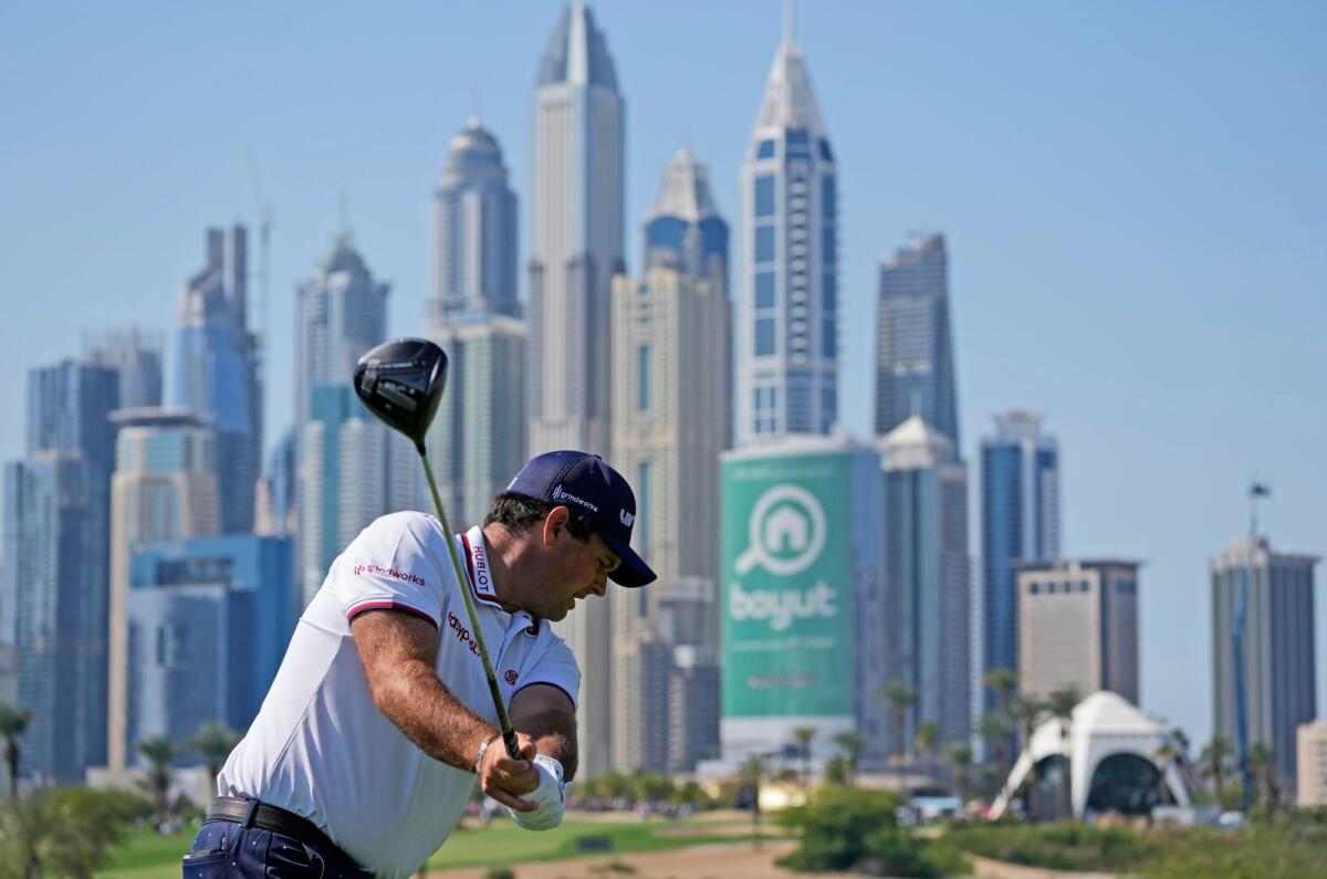 Patrick Reed of the United States tees off on the 8th hole during the third round of the Dubai Desert Classic. The 8th hole at the Emirates Golf Club is one of the most difficult holes in golf. — AP