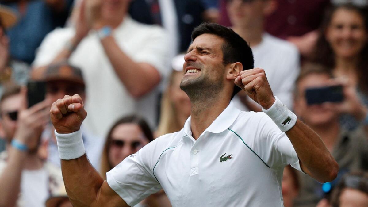 Serbia's Novak Djokovic celebrates his victory over Italy's Matteo Berrettini during their men's Wimbledon final. — AFP