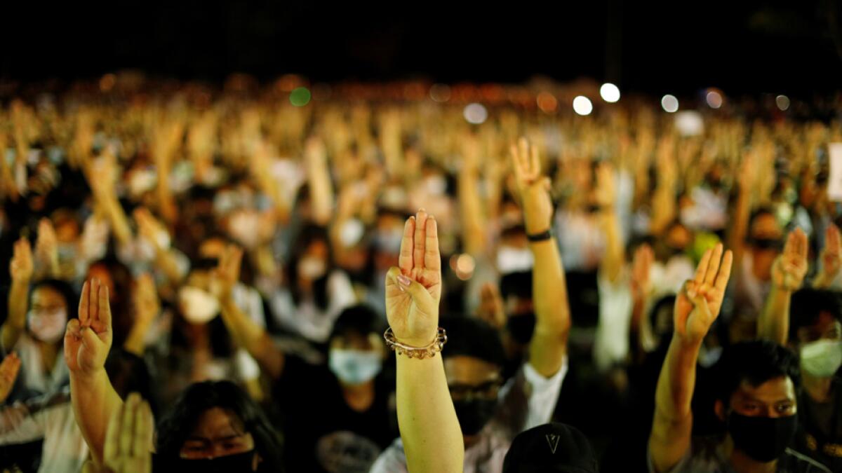 Pro-democracy protesters do a three-fingered salute as they attend a rally to demand the government to resign, to dissolve the parliament and to hold new elections under a revised constitution, at Thammasat University's Rangsit campus outside of Bangkok, Thailand. Photo: Reuters