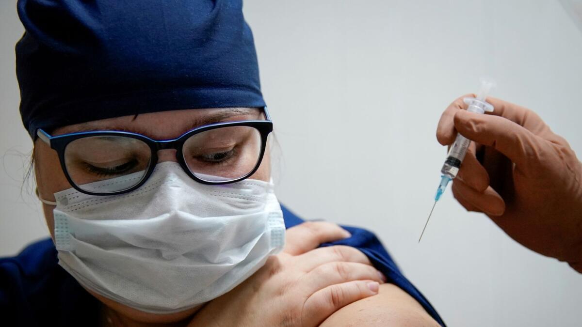 A medic of the regional hospital receives  Russia's 'Sputnik V' vaccine shot against the coronavirus disease (COVID-19) in Tver, Russia October 12, 2020.