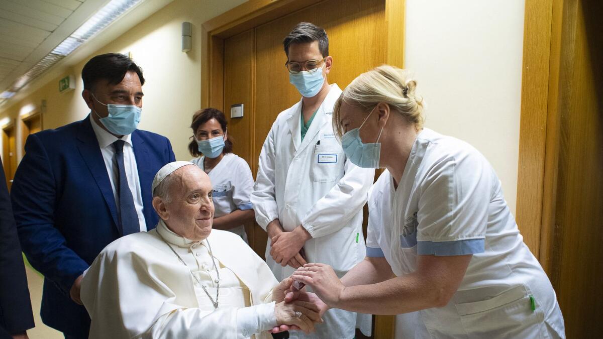 Pope Francis speaks with a nurse at Gemelli Hospital, in Rome, where he underwent a colon surgery. Photo: AFP
