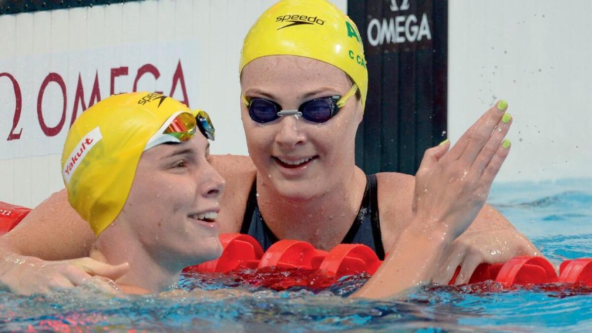 Australia’s Cate Campbell (right) and Bronte Campbell react at the end of a preliminary heat of the women’s 100m freestyle swimming event on Thursday. 