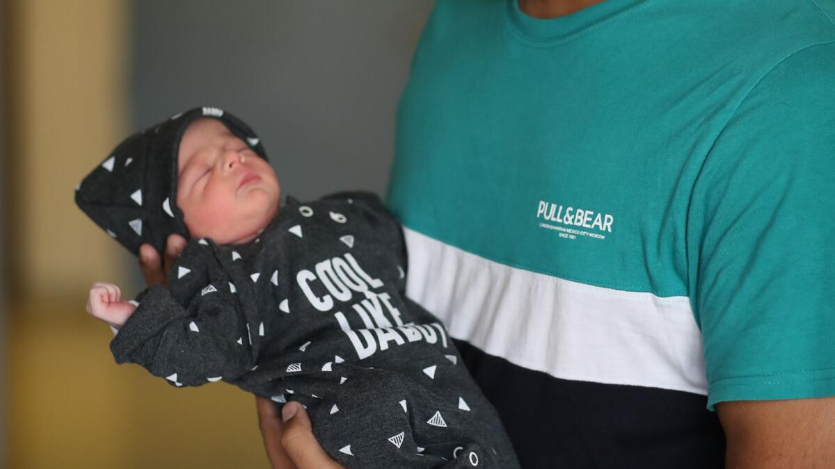 Irfan Khan holding newborn son Shahmeer Khan
