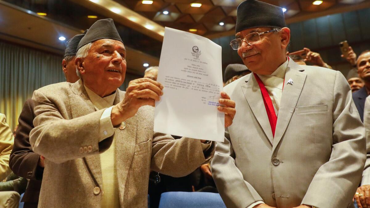Nepalese Prime Minister Pushpa Kamal Dahal, right, looks on as Ram Chandra Poudel of the Nepali Congress party, left, shows his candidacy papers after filling his nomination to become Nepal's next president as in Kathmandu, Nepal, on February 25, 2023. — AP