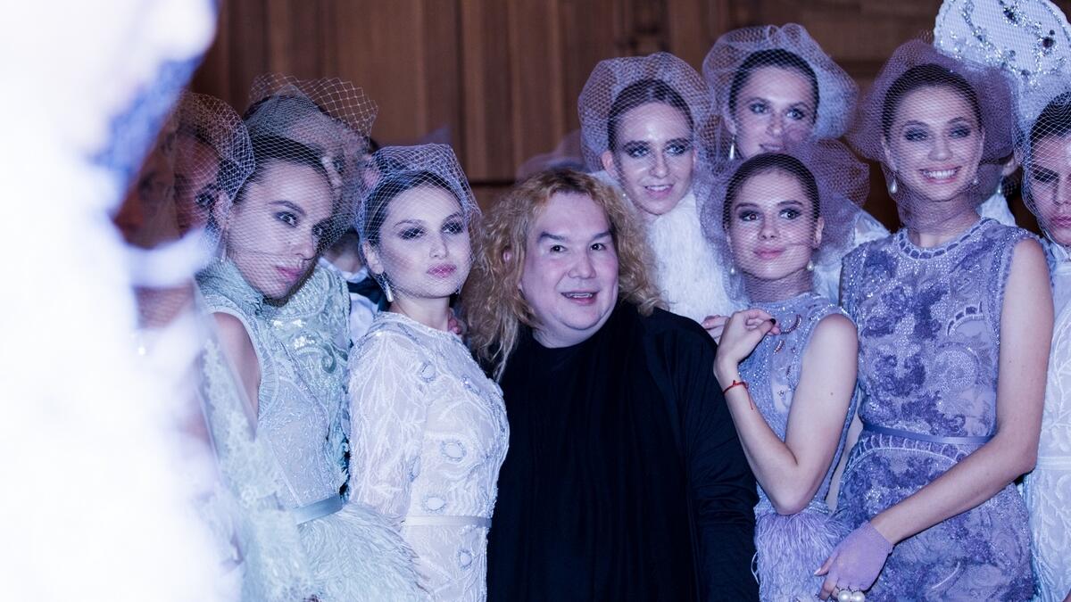 Dubai-based designer Furne One of Amato Couture poses with models from his show