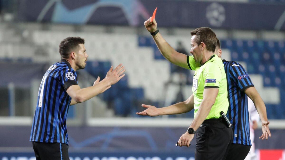 Referee Tobias Stieler shows a red card to Atalanta's Remo Freuler during the Champions League match against Real Madrid. — AP