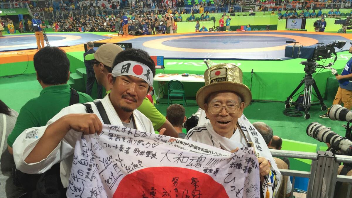 Kazunori Takishima poses with a Japanese fan at the 2016 Rio Olympic Games. (Reuters)