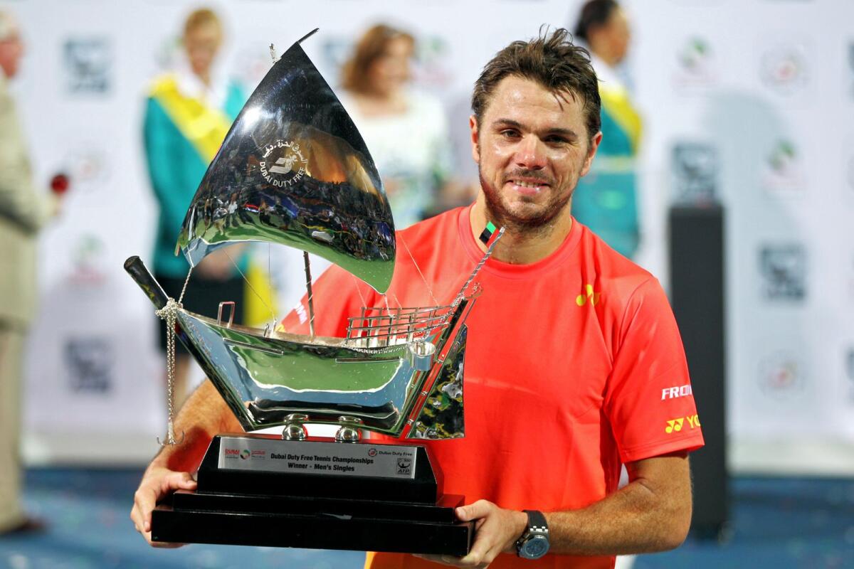 Stan Wawrinka of Switzerland poses with the trophy in 2016. — KT file