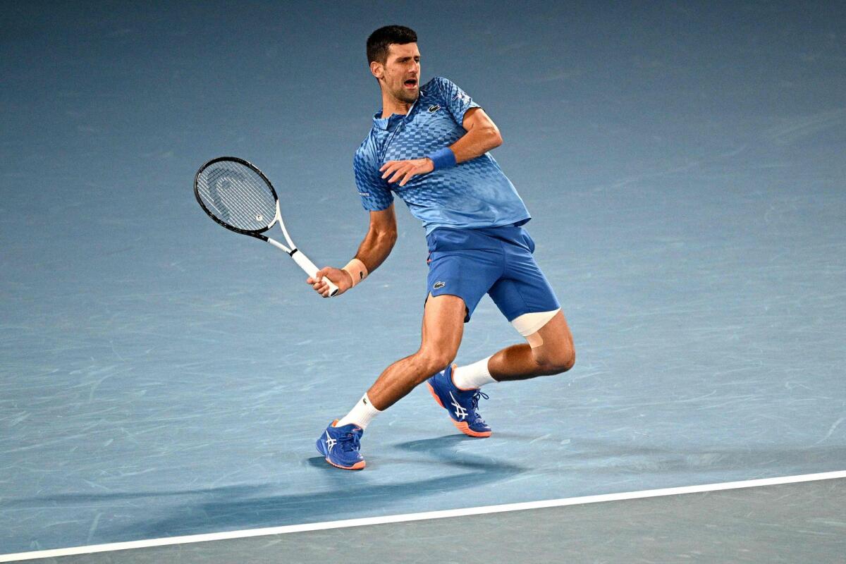 Serbia's Novak Djokovic hits a return against Bulgaria's Grigor Dimitrov during their men's singles match of the Australian Open in Melbourne on Saturday. —AFP