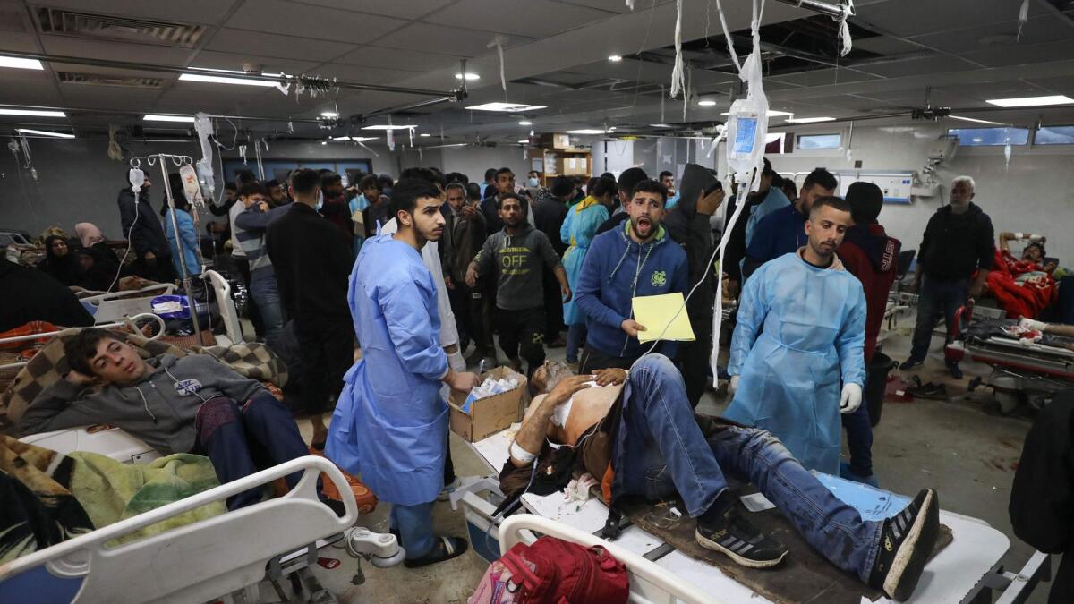 Injured people receive treatment in Gaza City's Al Shifa hospital, following a reported  Israeli strike, that killed at least 20 and wounded more than 150 as they waited for humanitarian aid. — AFP