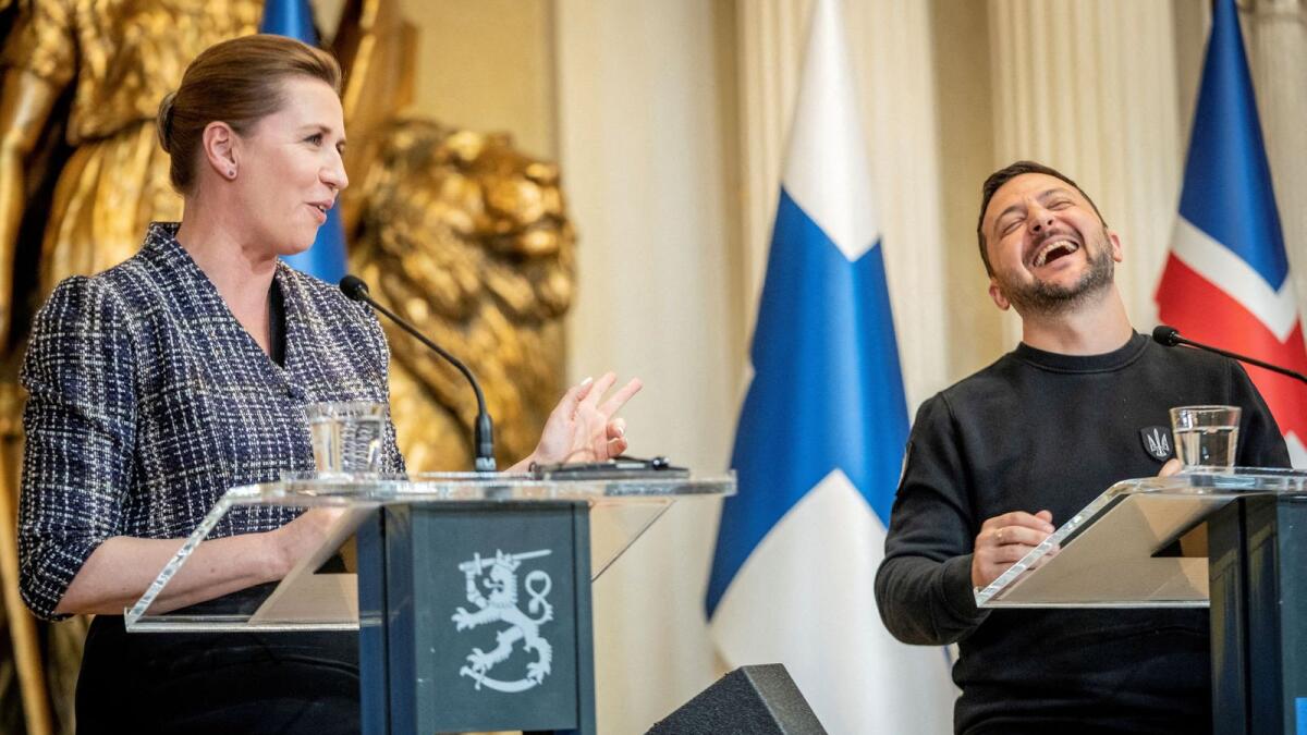 Danish Prime Minister Mette Frederiksen and Ukrainian President Volodymyr Zelenskiy laughs at a press conference with the Nordic heads of state during the Nordic-Ukrainian Summit, at the Presidential Palace in Helsinki, Finland, on May 3. — Reuters file