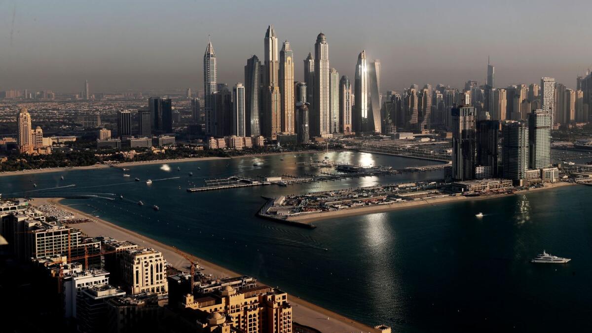 Luxury towers that dominate the skyline in the Dubai Marina district, centre, and the new Dubai Harbor development, right, are seen from the observation deck of 'The View at The Palm Jumeirah' in Dubai. — AP