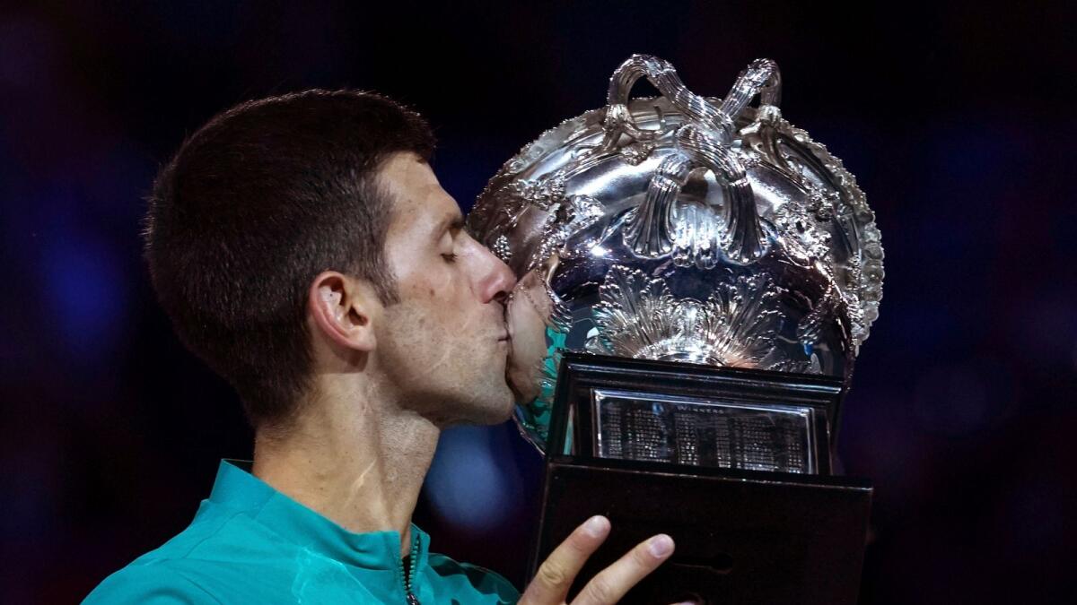Serbia's Novak Djokovic kisses the Norman Brookes Challenge Cup after defeating Russia's Daniil Medvedev in the men's singles final at the Australian Open. — AP